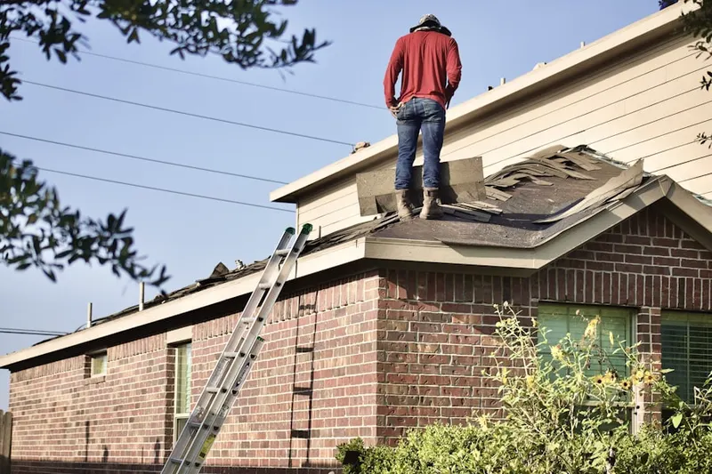 Professional roofer working on a residential roof in Brooklyn Heights